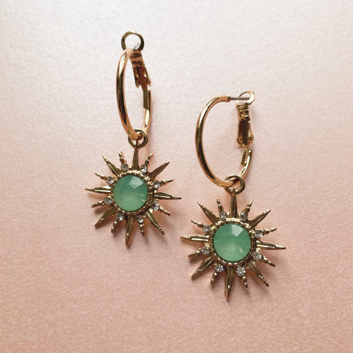 Gold-tone hoop earrings with aqua acrylic gemstone sunburst charm Solina Aqua Gem