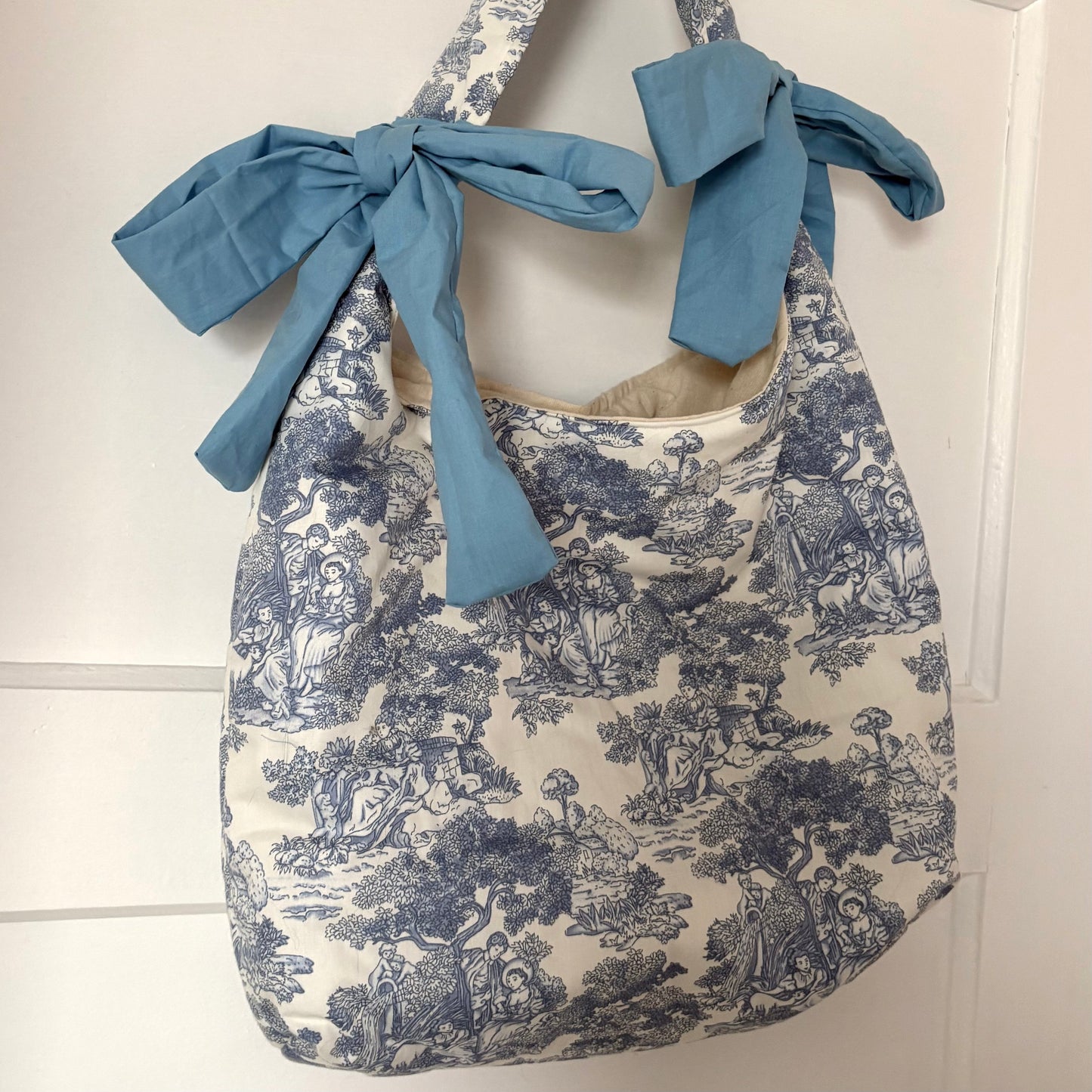 Handmade white and blue porcelain coquette farm print padded tote bag with blue bows