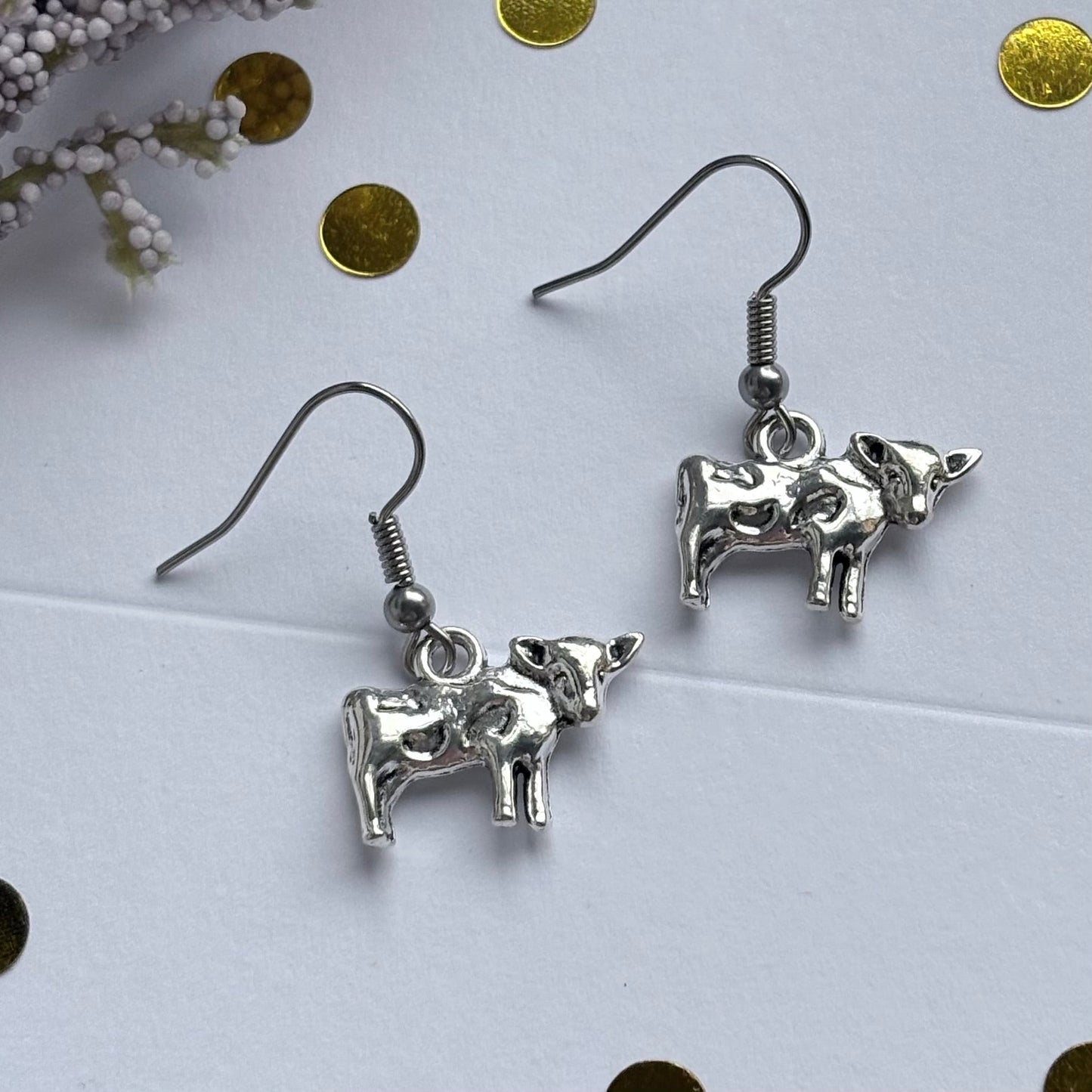 Silver cow earrings on hypoallergenic hooks