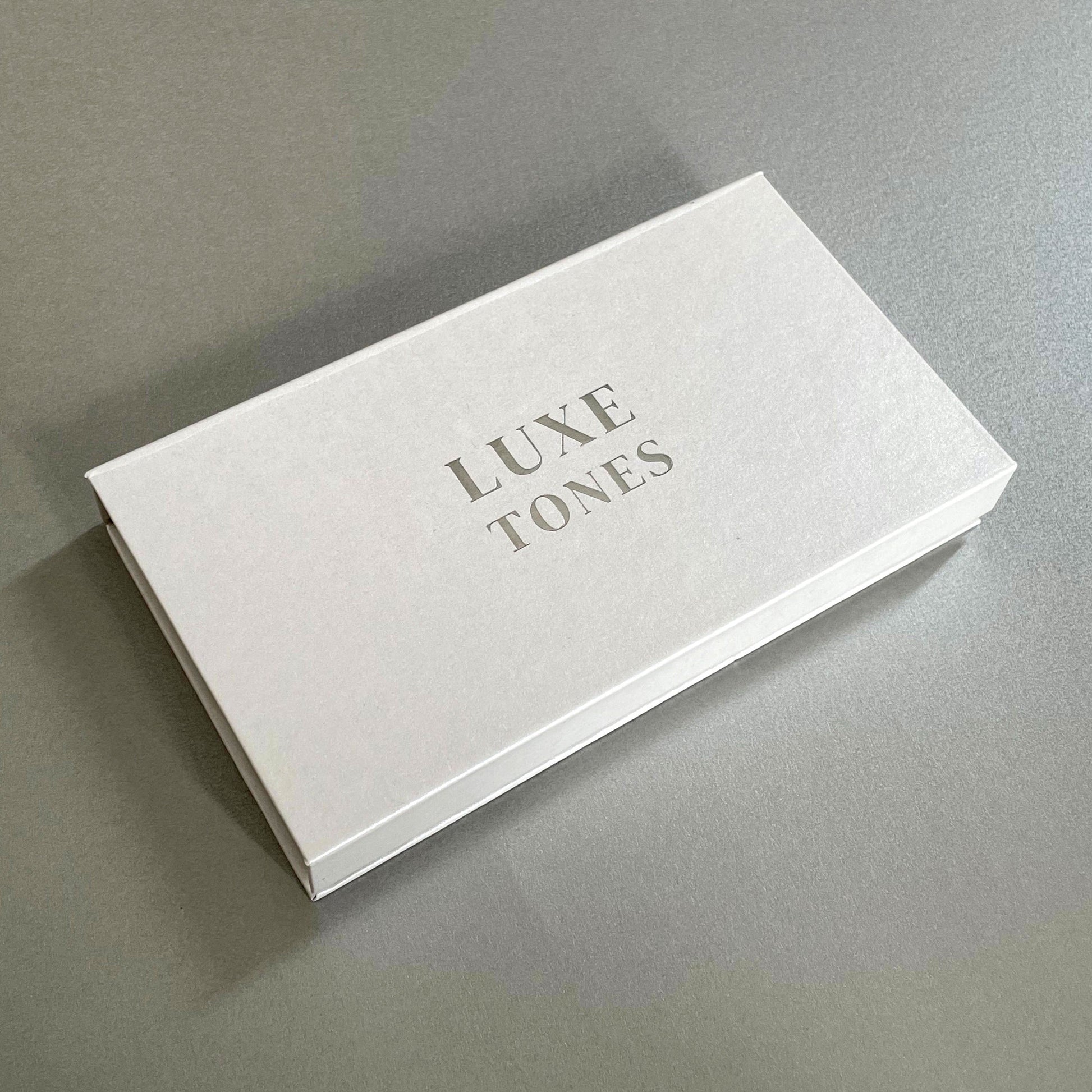 White magnetic rectangle gift box with Luxe Tones branding measuring 16cm by 9cm by 2cm