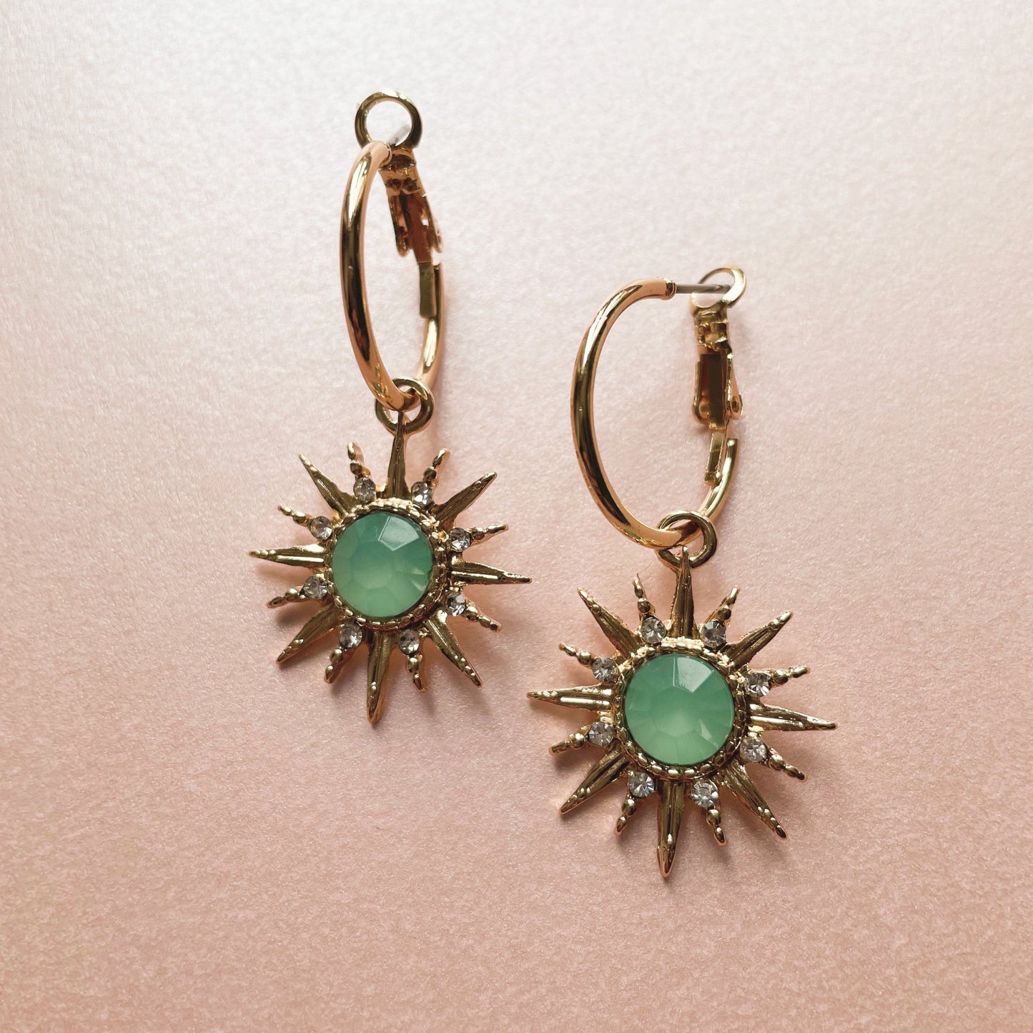 Gold-tone hoop earrings with aqua acrylic gemstone sunburst charm Solina Aqua Gem