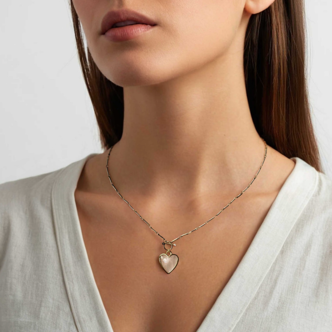 Sanora Luxe 18k gold plated chain necklace with heart-shaped rose quartz pendant on woman's neck